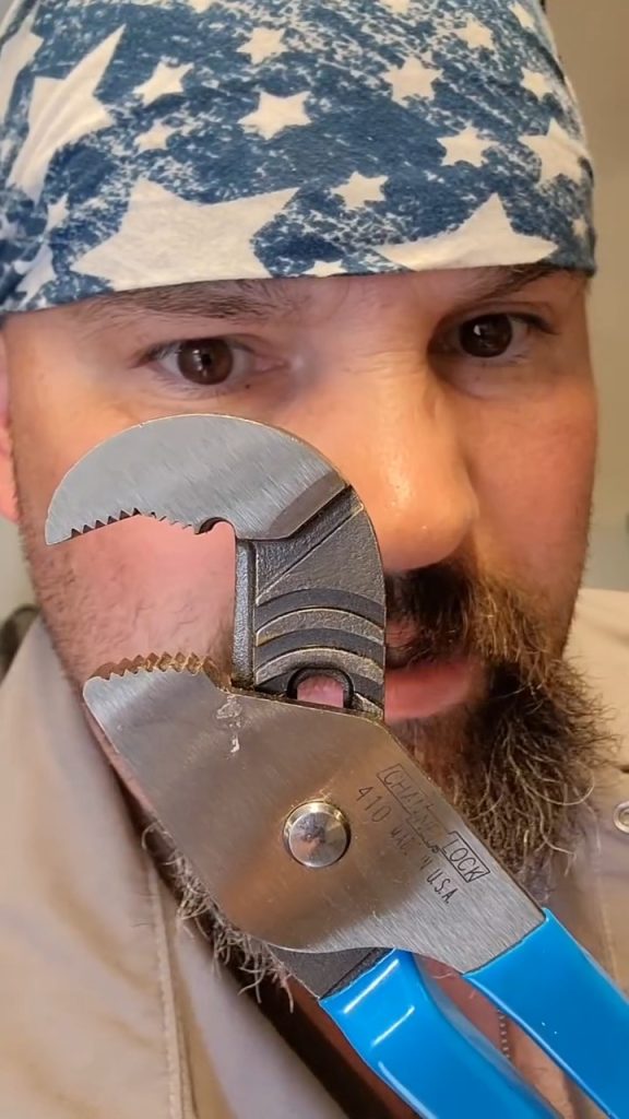 A man wearing a star-pattern bandana holds CHANNELLOCK® blue-handled adjustable pliers near his face.